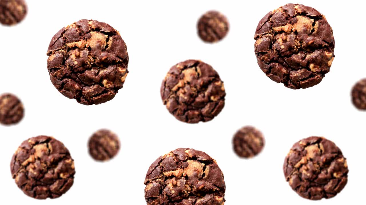 A stream of Christmas Collection of half chocolate chip cookies of different diameters on a white color background. 4K UHD footage. Futuristic design, motion design animation. Pop art design, creative Christmas sweets food concept