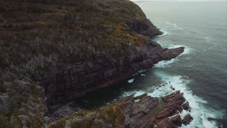 rugged coastline of eastern canada with powerful waves crashing against the rocky shore