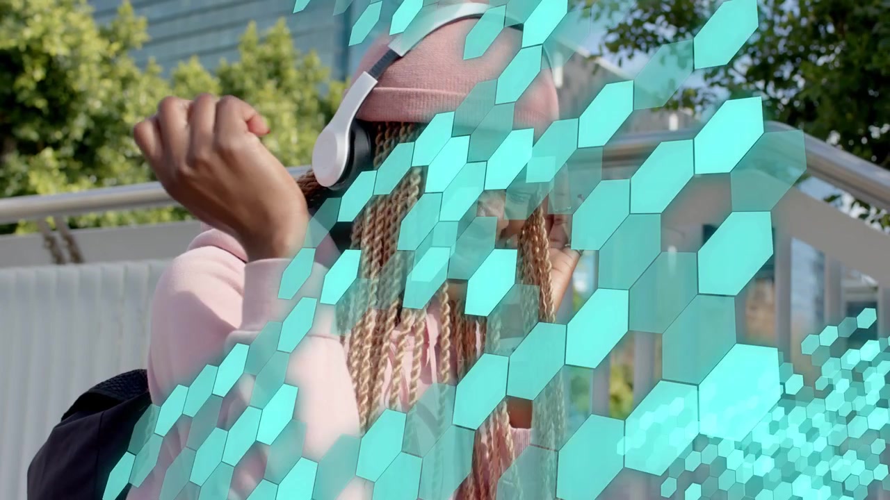 Woman on steps tapping headset while teal hex graphic sweeping, initiating rhythmic music reaction