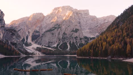 Cinematic-Establishing-Shot-Above-Lago-di-Braies-in-Italian-Dolomites-on-Autumn-Morning