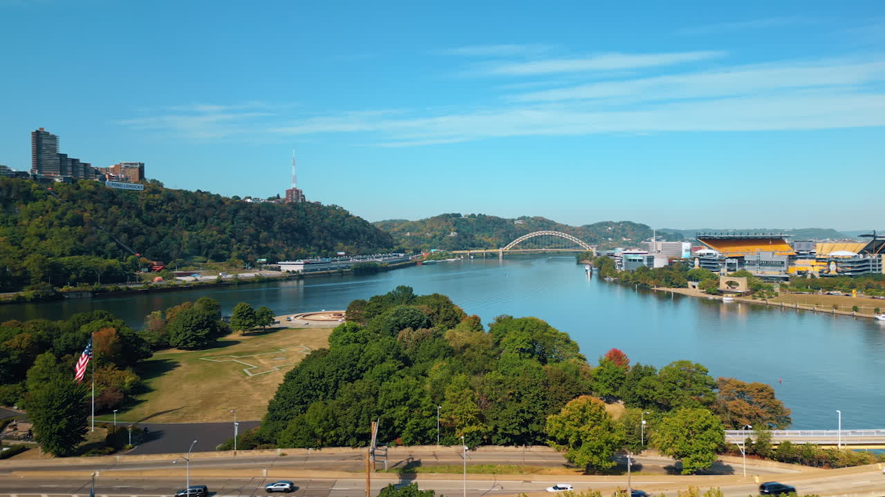 Piyysburgh, USA, 3 August 2025: Pittsburgh riverfront with bridge and hills. Aerial view of Pittsburgh riverfront with a bridge, hills and green landscape