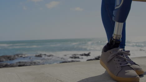 animation of scope scanning over woman with artificial limb standing by seaside