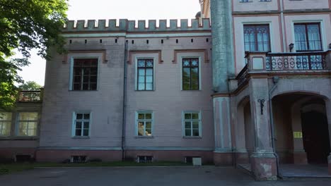 Vecauce-Manor-in-Latvia-Aerial-View-of-the-Pink-Castle-Through-the-Park