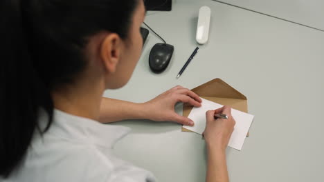 woman writing 'boy' on a paper