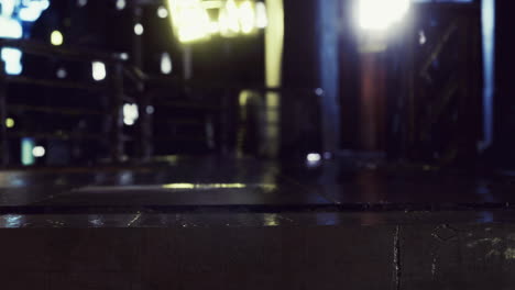 Reflections of light on a wet surface in an urban setting at night