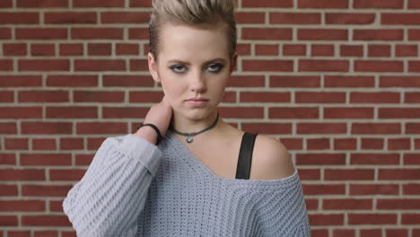 fashion portrait of young stylish woman looking vulnerable running hand through hair