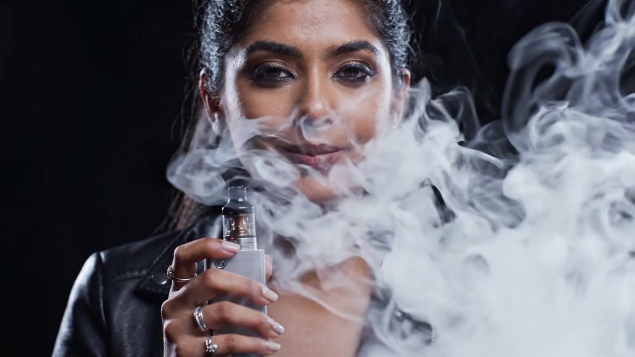 A Confident Vaper: Captivating Journey from Anticipation to Exhilaration Through the Clouds of Vapor in a Stylish Black Ensemble