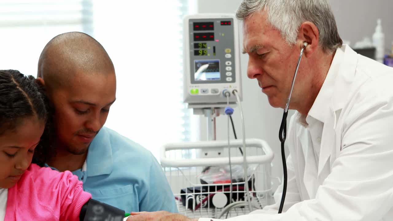 Male doctor checking patient blood pressure