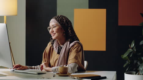 middle eastern woman video calling in office