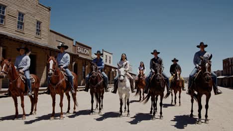 cowboys on horses in a western town