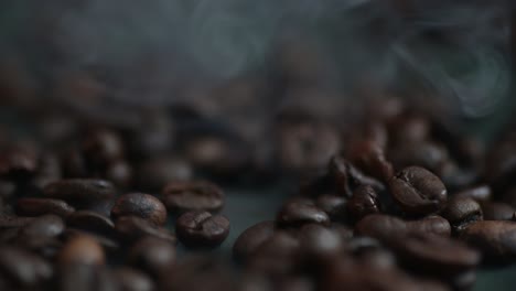 hand pouring hot steaming coffee beans