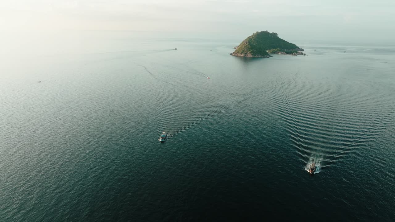 Aerial view of Turtle Island near Ko Tao, Thailand, with boats creating ripples