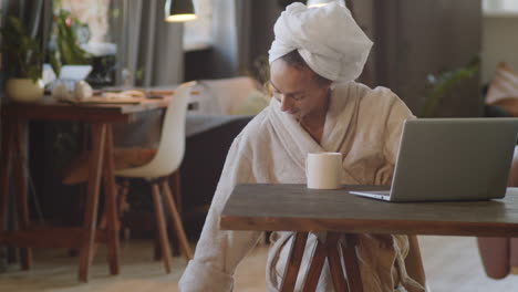 woman working from home in bathrobe