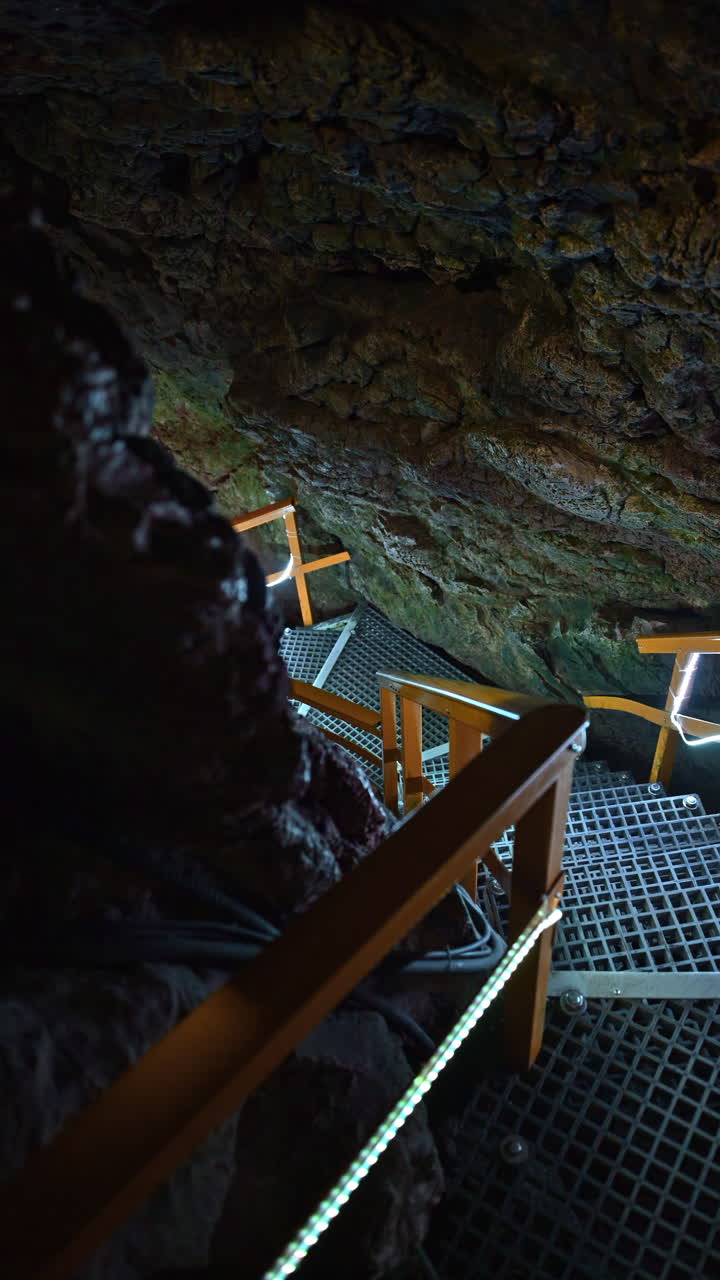 Stairs and rails inside of the Ialomita Cave in the Bucegi Mountains in Romania. Vertical