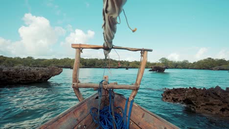 Rustic-wood-sailing-boat-in-a-rocky-shore-on-beautiful-landscape