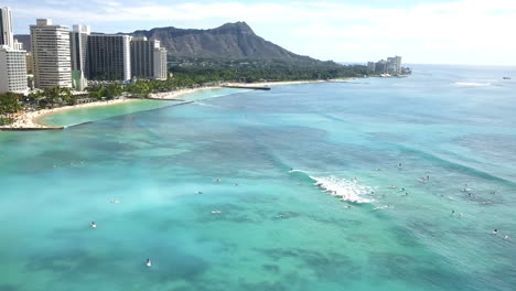 aerial view over waikiki beach with many surfers in honolulu, hawaii