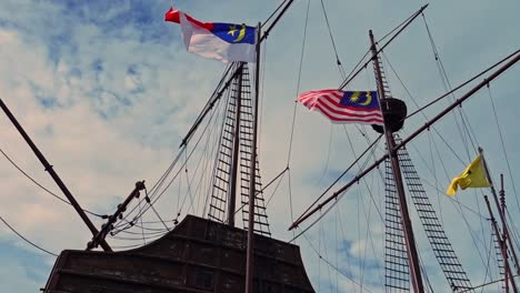 malaysian flags flattering on the wind with beautiful sky on the background -wide shot