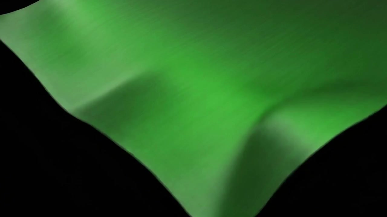 Tessuto verde che ondeggia e scompare su sfondo nero