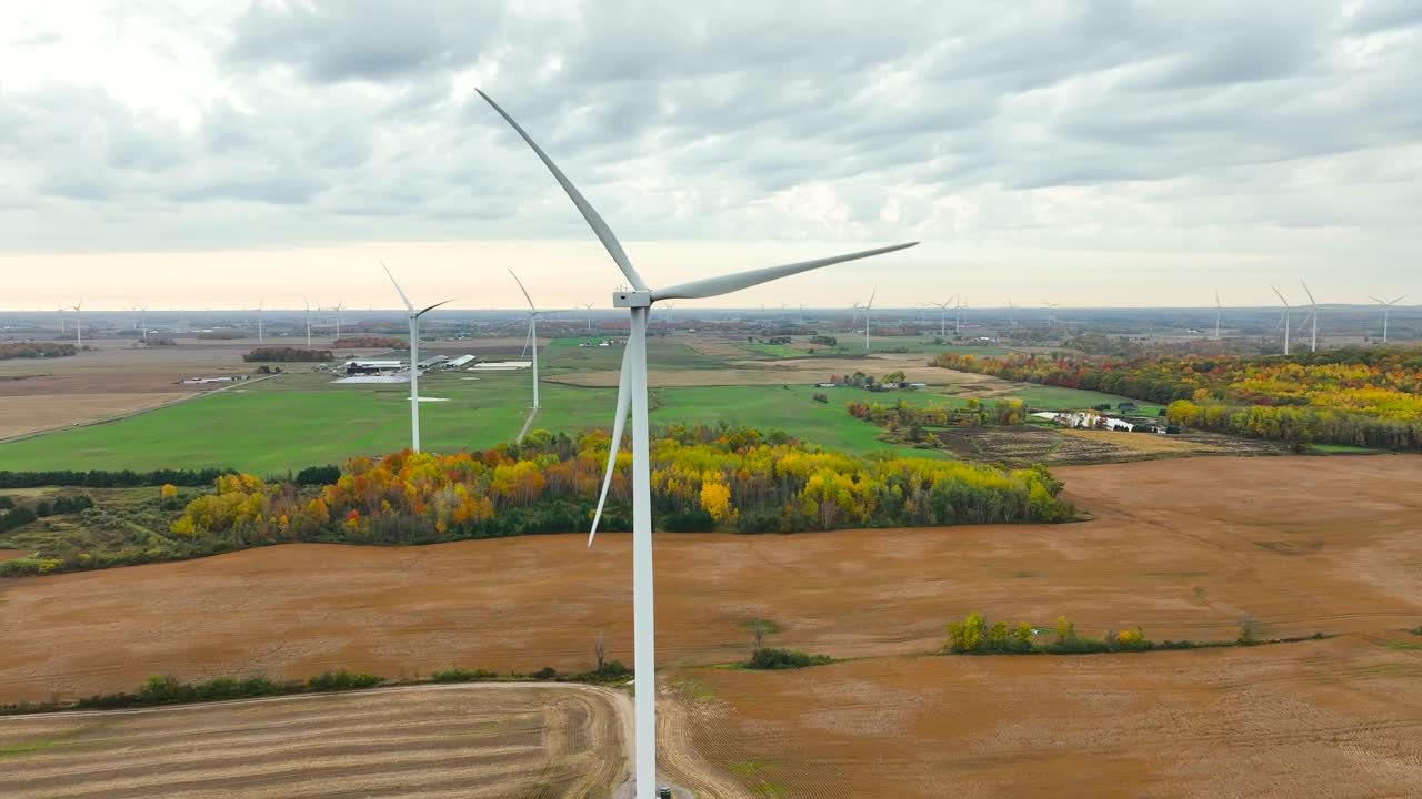 Premium stock video - A wind turbine on a cloudy and stormy fall day