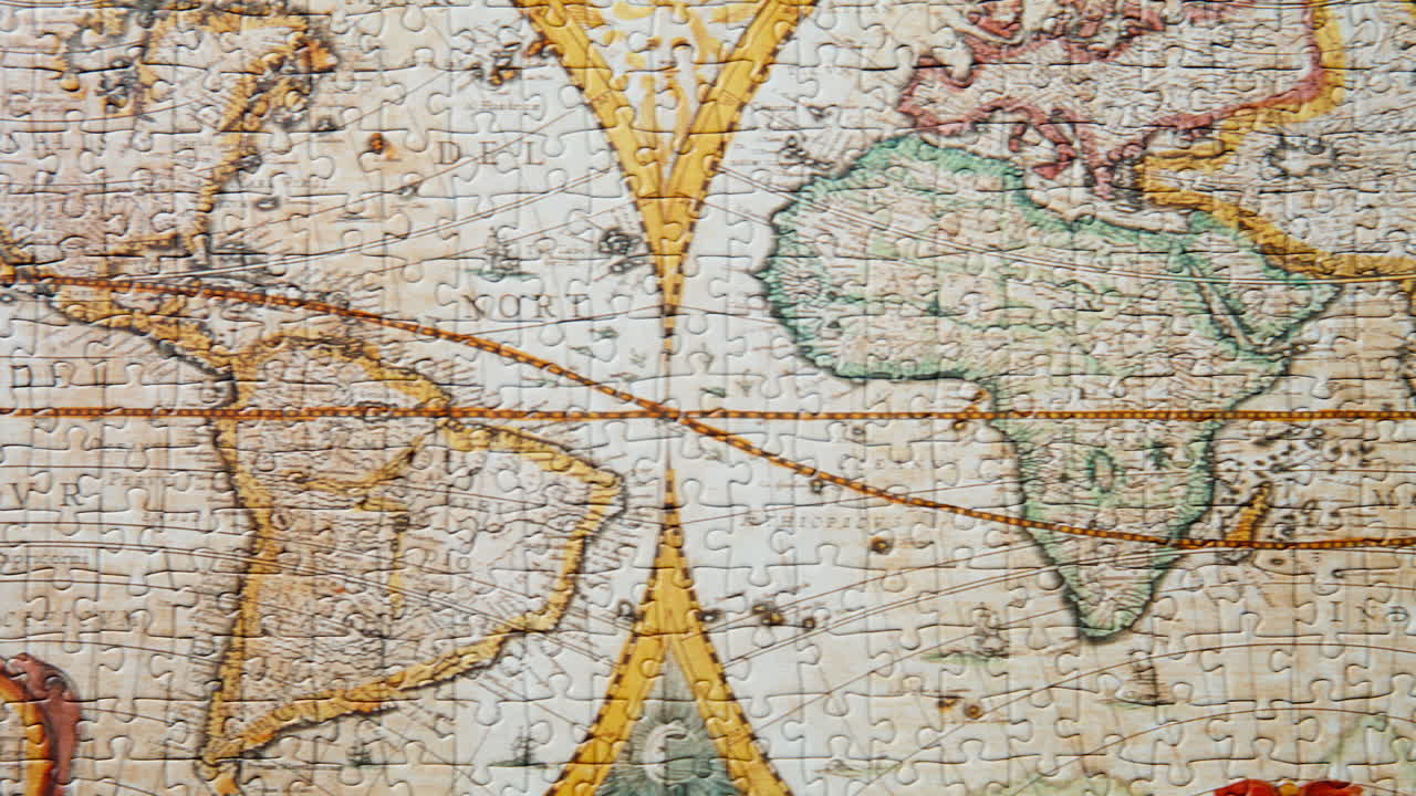 Moving shot completed jigsaw featuring world map. Puzzle pieces fit tightly