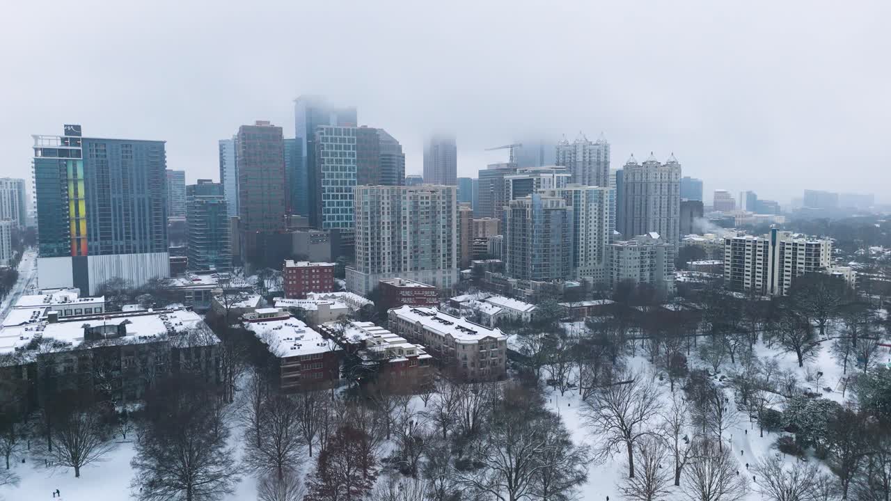 Aerial shot pushing in on snow covered buildings in Midtown Atlanta on January 10th 2025.