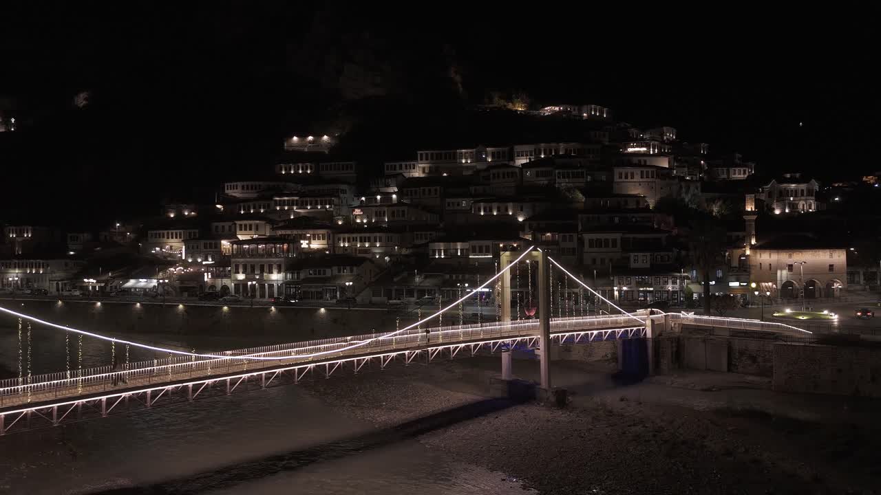 Peaceful night cityscape in Berat, Albania, with glowing bridge lights