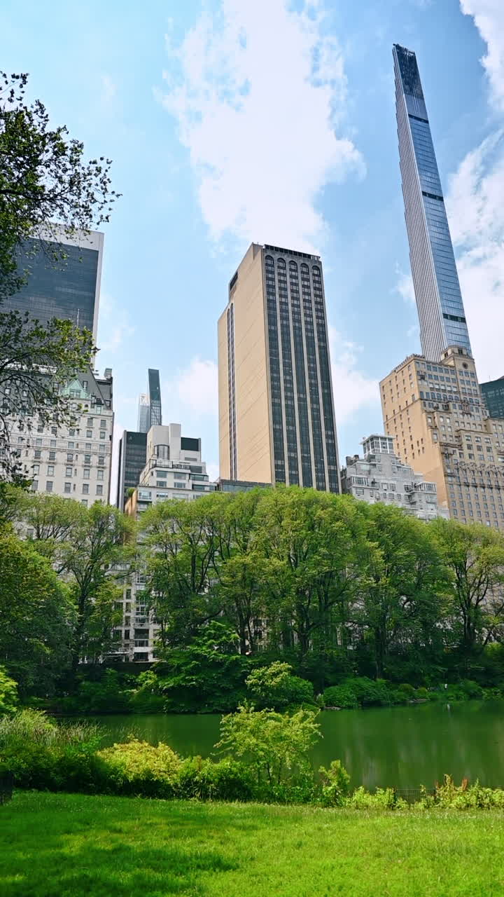 New York, USA, 28 July 2025: Central Park view with towers. Lush greenery meets iconic Manhattan architecture on a bright day in Central Park, New York City