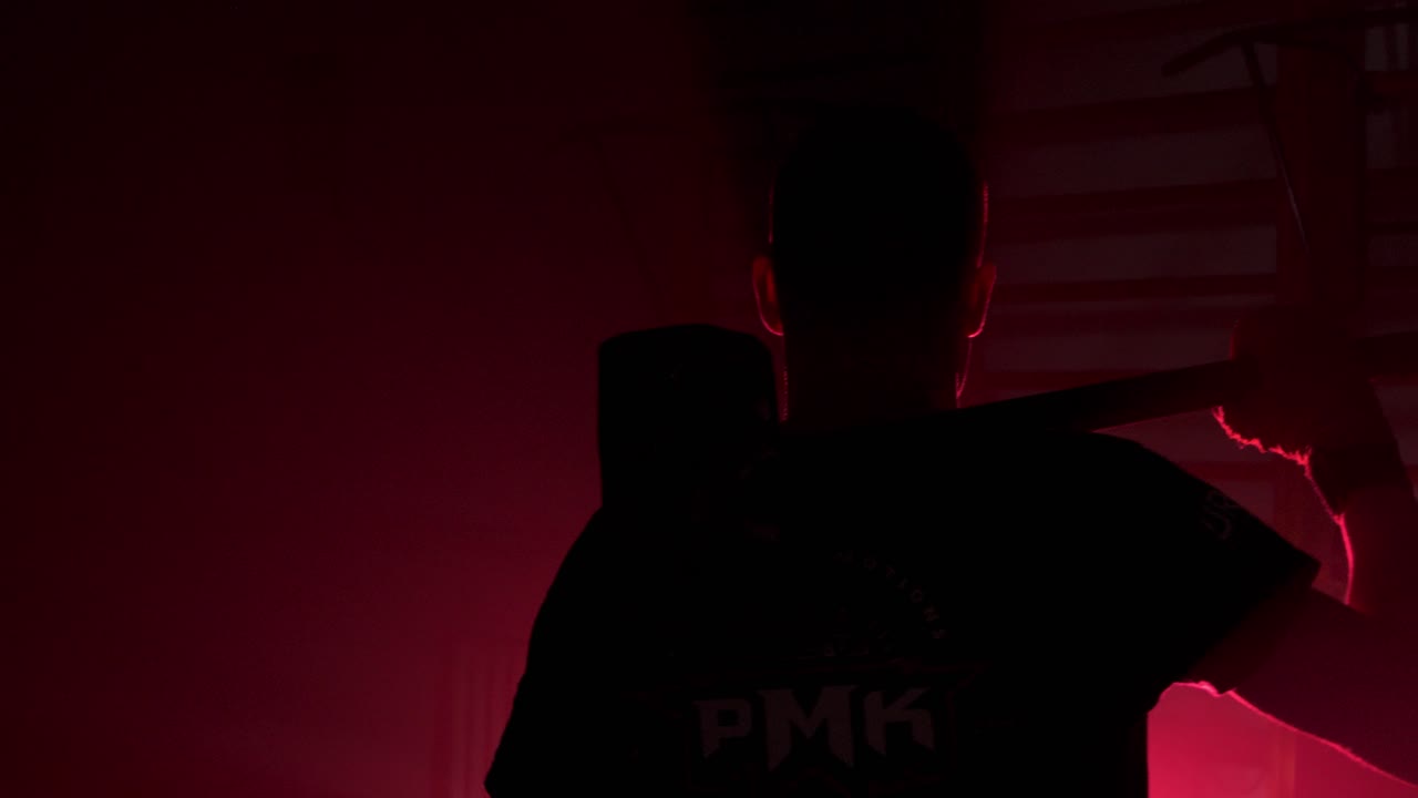 hombre en silueta con martillo, preparándose para el entrenamiento