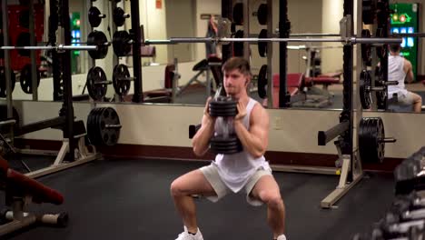 front shot of young bodybuilder doing goblet squats