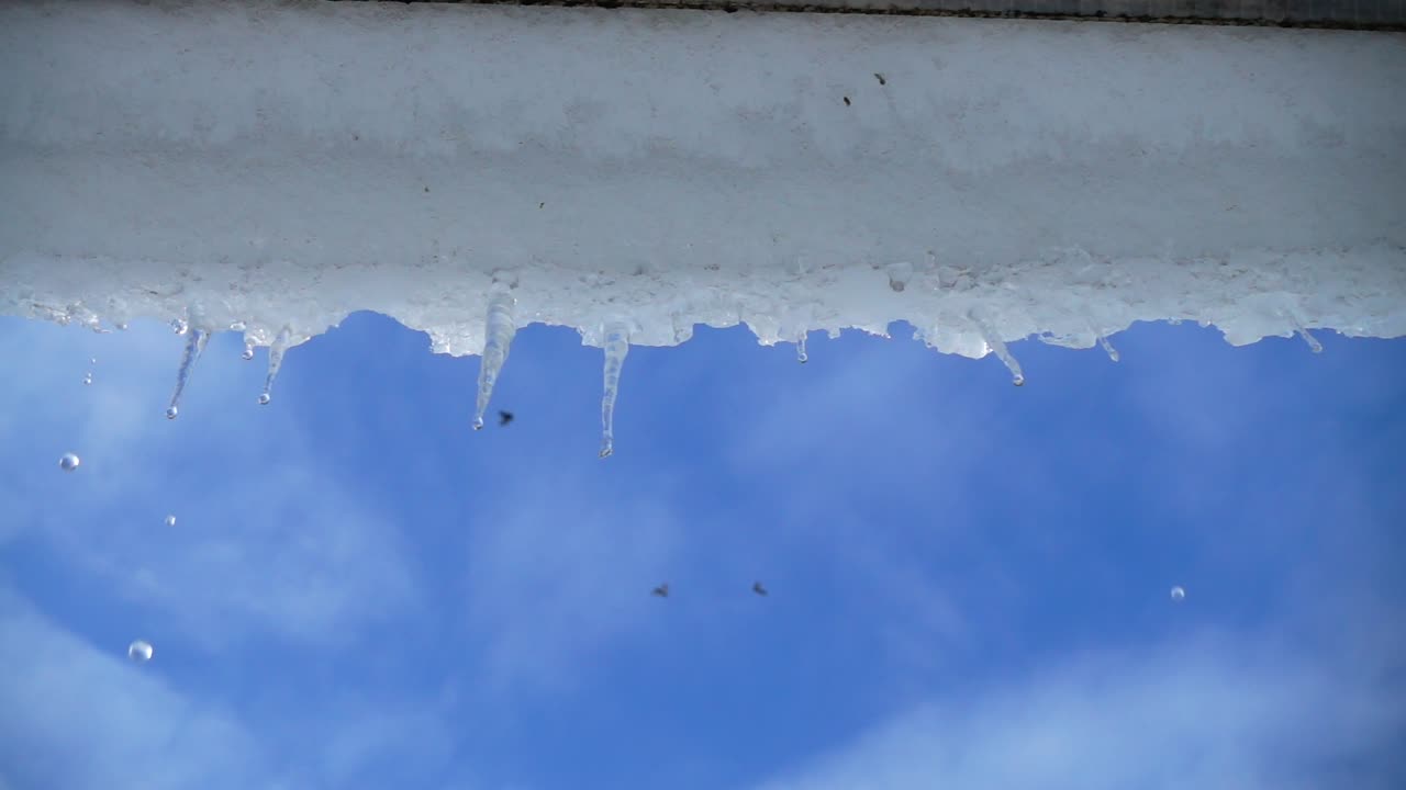 The water dripping from icicles. Shooting in the winter. Slow motion