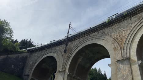 Semmering-Railway-World-Heritage-Unesco-Site-in-Austria-filmed-from-below-in-4K-surrounded-by-forest