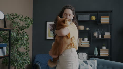 woman enjoying time with her dog in the living room
