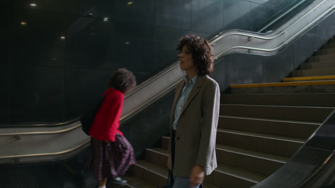 Woman walking down stairs in a subway station