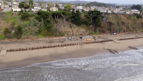 park rangers assessing damage by storm at the seacliff state beach in aptos, california, usa