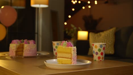 Slice-Of-Party-Celebration-Cake-For-Birthday-Decorated-With-Icing-On-Table-At-Home-5