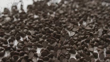 animation of chocolate crisps over white and grey background