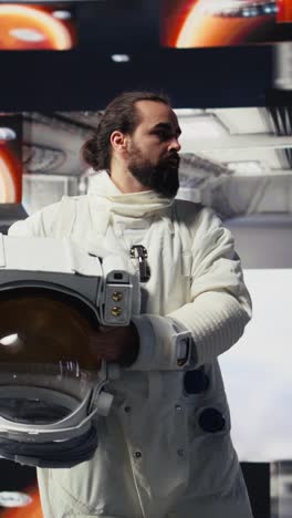 vertical video curious astronaut standing on a distant planet in space suit and helmet