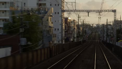 golden hour on tokyo’s tokyu line tracks experience a beautiful sunset ride along the tokyu line, with golden light reflecting off the tracks around naka meguro