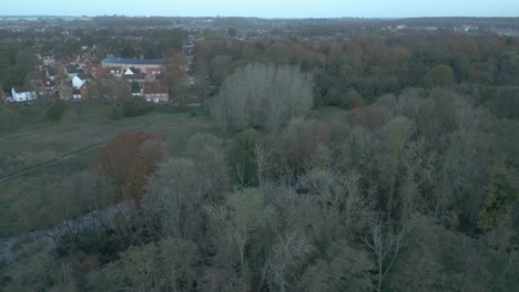 orbit aerial drone shot of of the outskirts of thetford showing the lush greenery and residential spaces, in the district of breckland, county of norfolk east of england in united kingdom