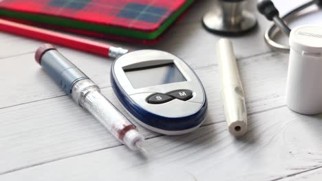 diabetes testing supplies: blood glucose meter, insulin pen, and lancet