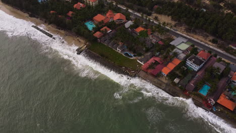 sandy beach gone due to coastal erosion of powerful sea, aerial orbit view