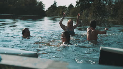friends having fun splashing in a lake