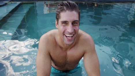 caucasian man enjoying the pool during a sunny day