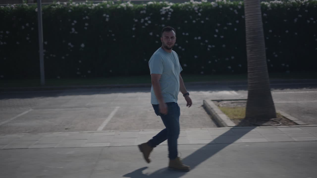 Man Walking in Parking Lot