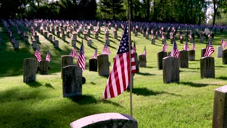 Waving-American-flag-placed-at-the-grave-sites-of-American-Soldiers-tombstone