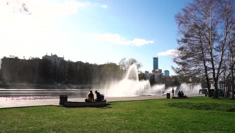 city park with fountains and people