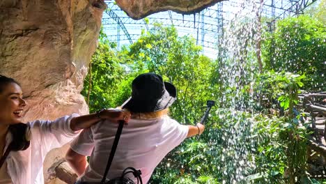 visitors enjoy waterfall at chonburi zoo