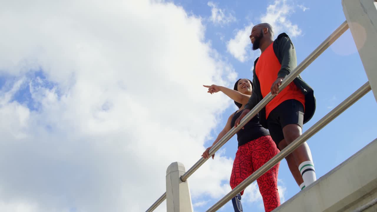 pareja interactuando entre sí cerca de la barandilla 4k