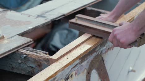 dry fitting wood plank into wooden boat