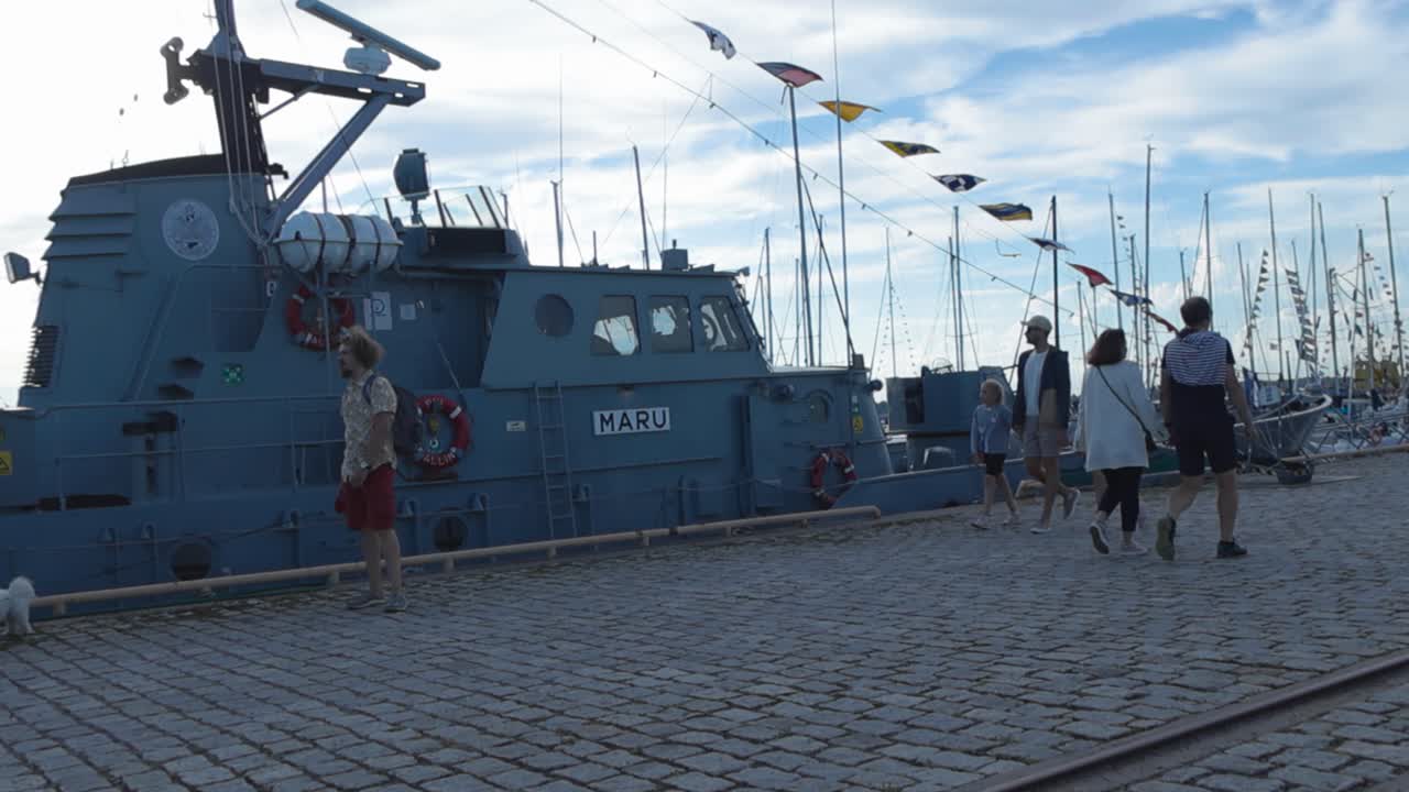 Boat on a dock with people and flags